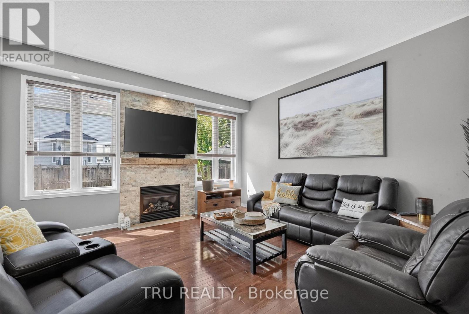 living room with gas fireplace - 325 Upcountry Drive E, Ottawa, ON