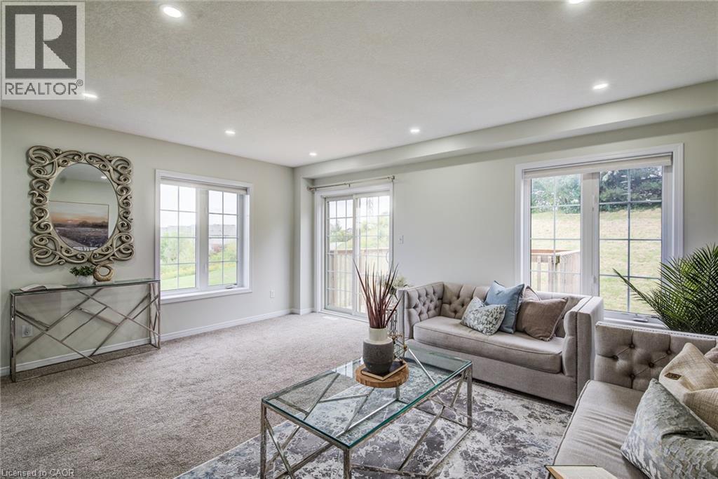 Recessed ceiling lighting, light-toned carpeting, multiple windows, and a glass sliding door - 226 Maitland Street, Kitchener, ON