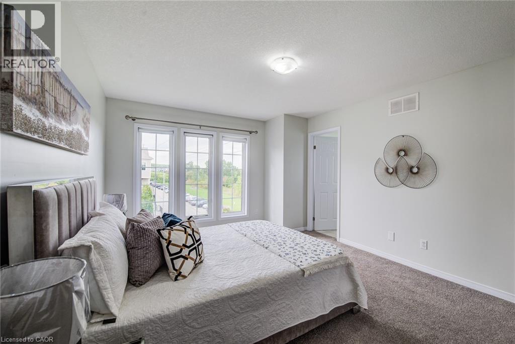 Bright room with a three-panel window, light-colored walls, and gray carpeting - 226 Maitland Street, Kitchener, ON