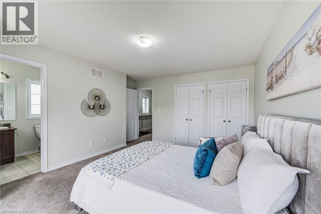 Carpeted flooring, light-toned walls, and twin bi-fold closet doors - 226 Maitland Street, Kitchener, ON