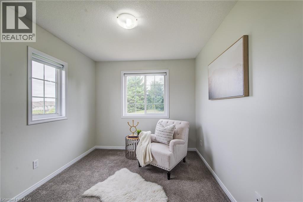 Recessed lighting, light-toned wall finishes, carpeted flooring, and two window installations - 226 Maitland Street, Kitchener, ON