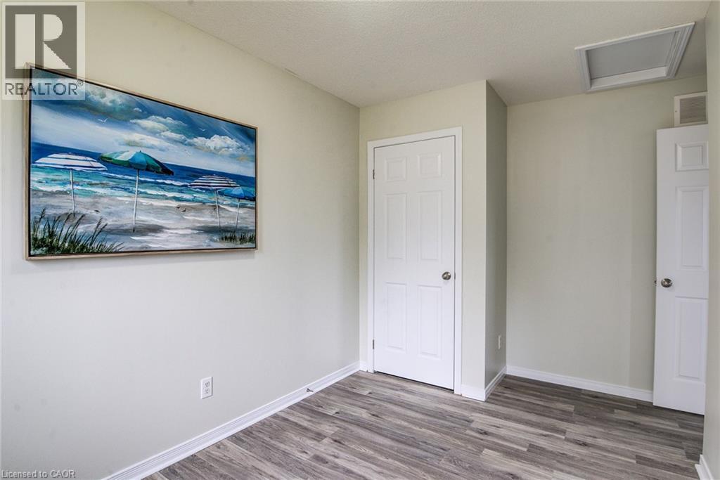 Wood-finish flooring with white trim and paneled doors - 226 Maitland Street, Kitchener, ON