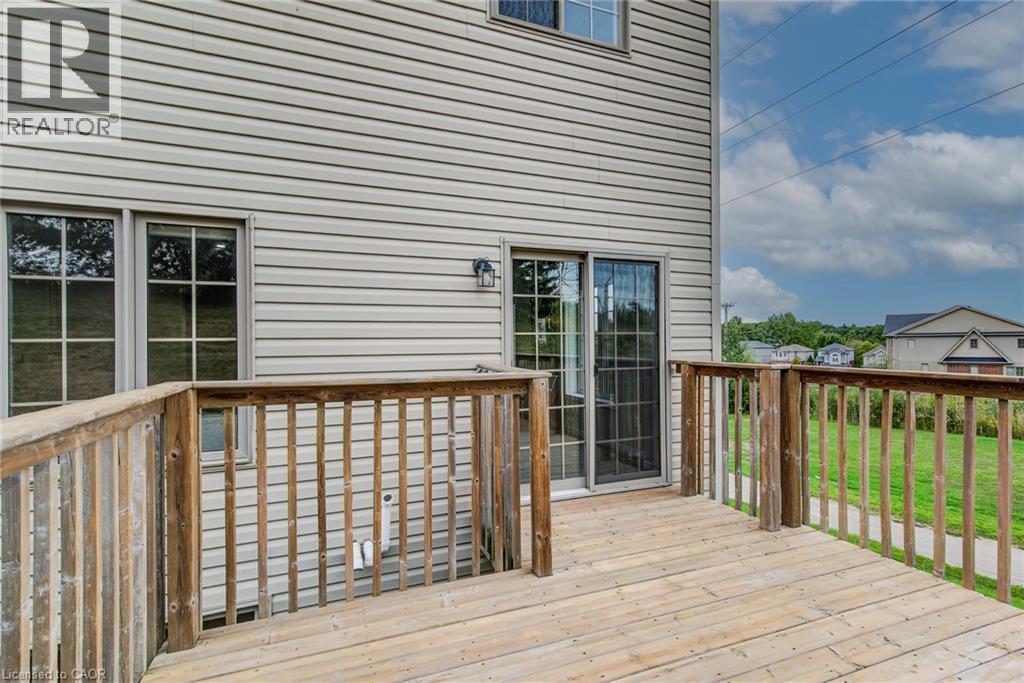 Expansive outdoor deck with wood railing, siding exterior, and sliding glass door - 226 Maitland Street, Kitchener, ON