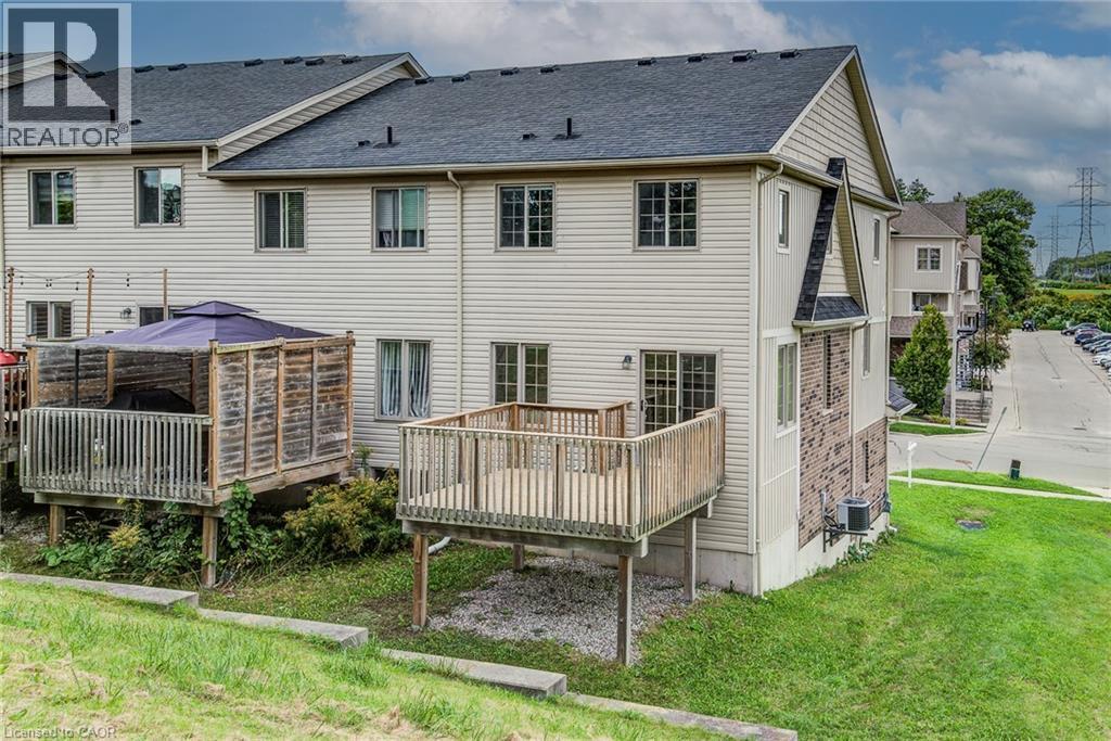 Rear exterior featuring a wood deck and a ground-level patio area - 226 Maitland Street, Kitchener, ON