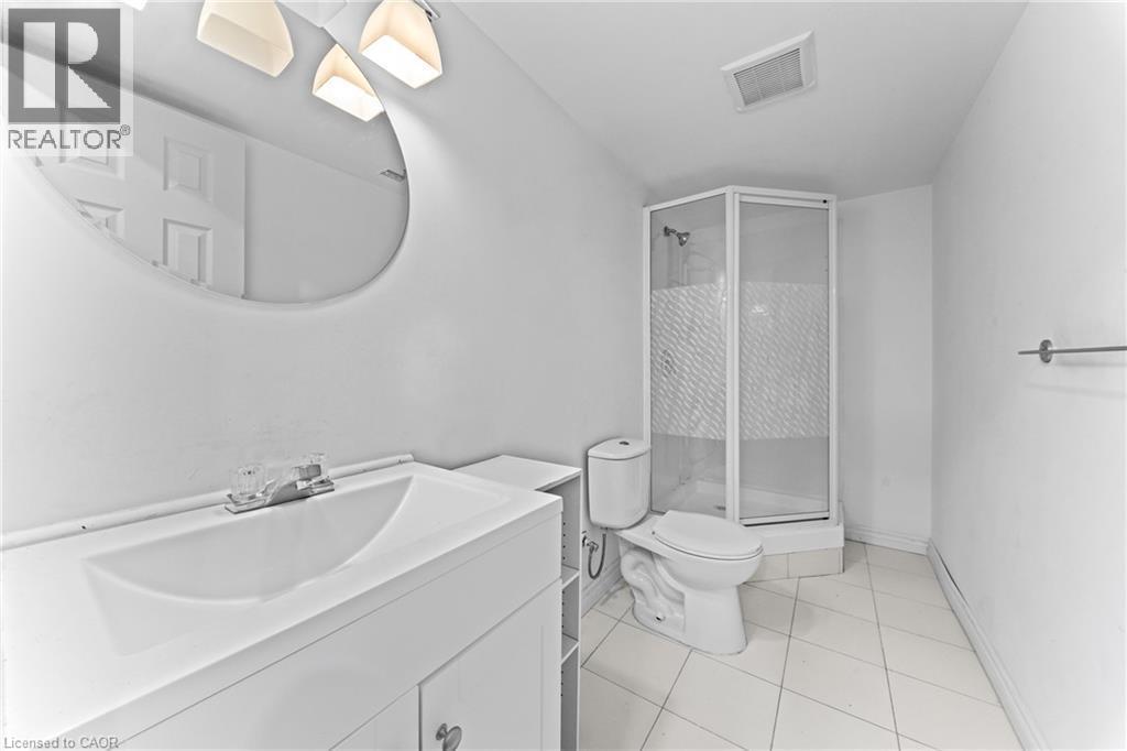 White vanity with an integrated sink and chrome faucet - 245 Red Clover Court, Kitchener, ON