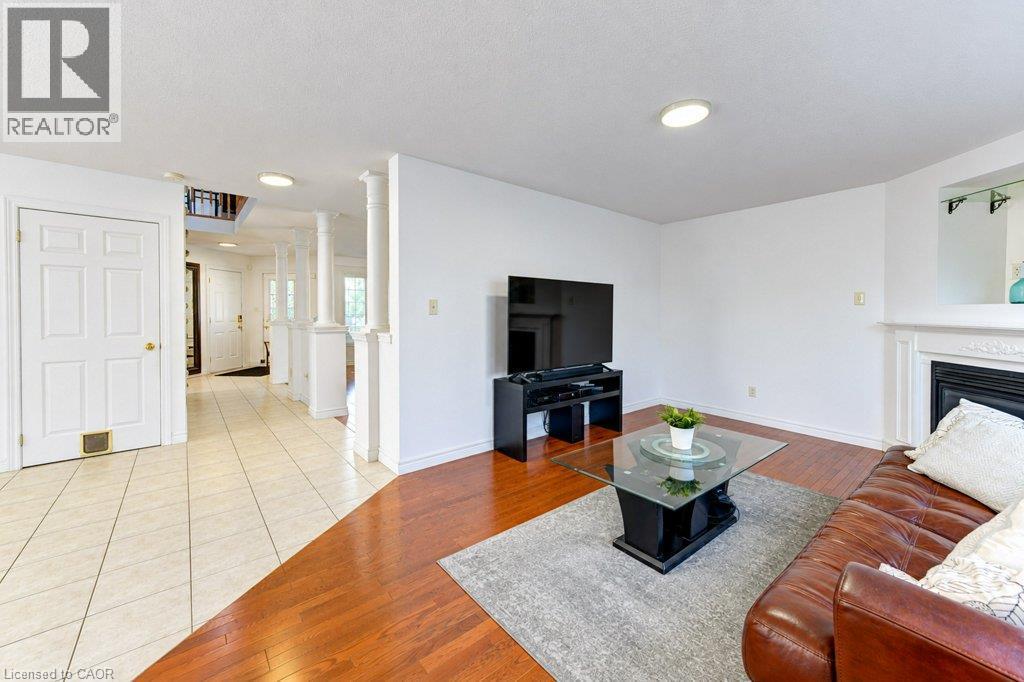 Hardwood flooring, recessed lighting, white fireplace mantel, and a tiled entryway - 88 Decaro Crescent, Cambridge, ON