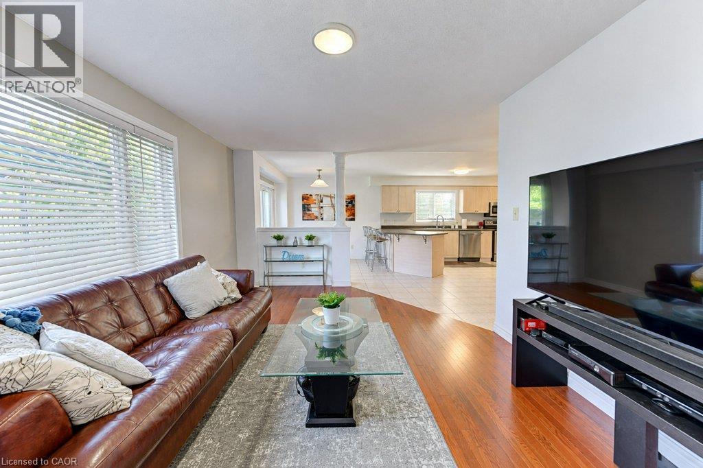 Hardwood-finish flooring, recessed lighting, and a partial wall with an open concept design - 88 Decaro Crescent, Cambridge, ON