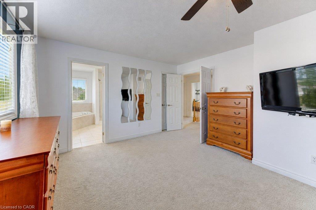 Plush carpeting throughout, white painted walls, and a ceiling fan with integrated lighting - 88 Decaro Crescent, Cambridge, ON