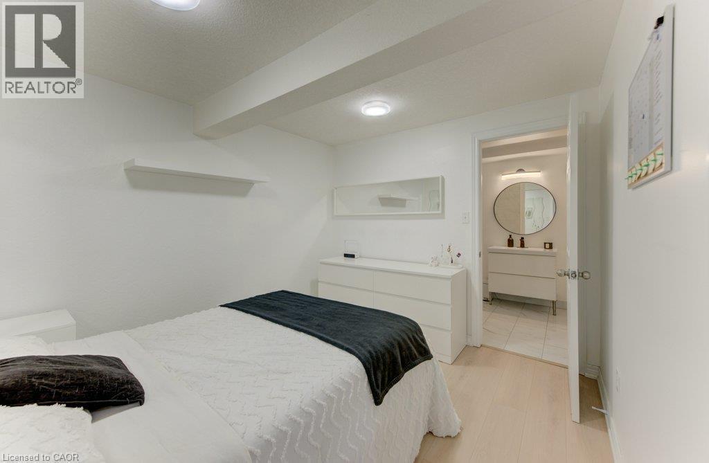 White walls complement light wood-finish flooring - 88 Decaro Crescent, Cambridge, ON