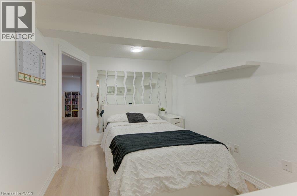 White walls featuring a floating shelf and wood-finish flooring - 88 Decaro Crescent, Cambridge, ON