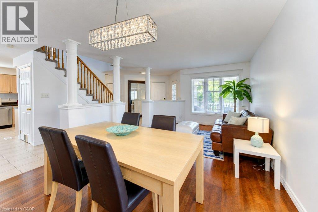 Hardwood flooring, decorative columns, a contemporary chandelier, and a white-framed window - 88 Decaro Crescent, Cambridge, ON