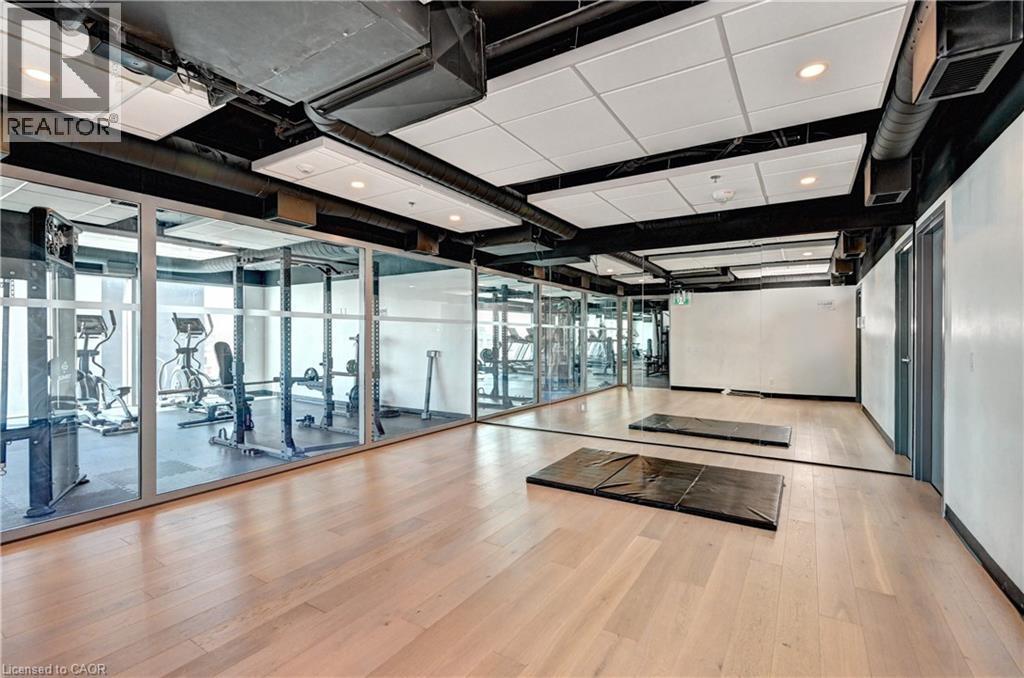 Wood-finish flooring, full-height wall mirrors, and recessed ceiling lighting - 60 Frederick Street Unit# 1213, Kitchener, ON
