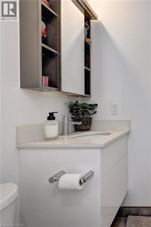 Floating vanity with an integrated sink, polished chrome faucet, and coordinating wall-mounted medicine cabinet with sliding mirrored doors - 60 Frederick Street Unit# 1213, Kitchener, ON