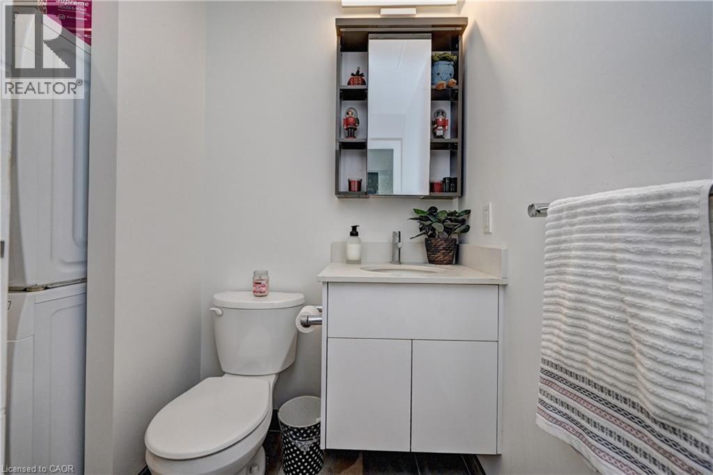 White vanity with an integrated sink and light-colored countertop - 60 Frederick Street Unit# 1213, Kitchener, ON