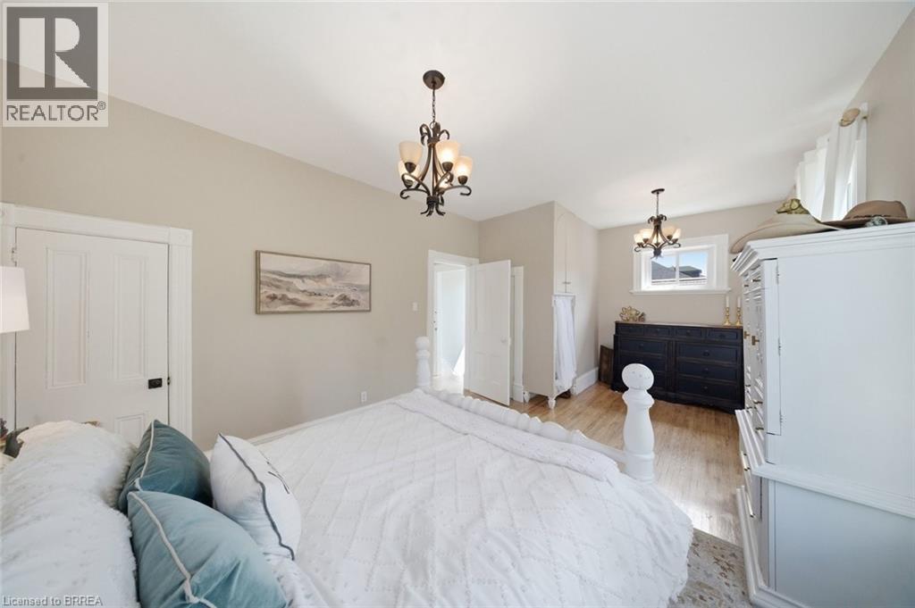 Hardwood flooring extends throughout this space featuring light-toned walls and crown molding - 62 East Avenue, Brantford, ON