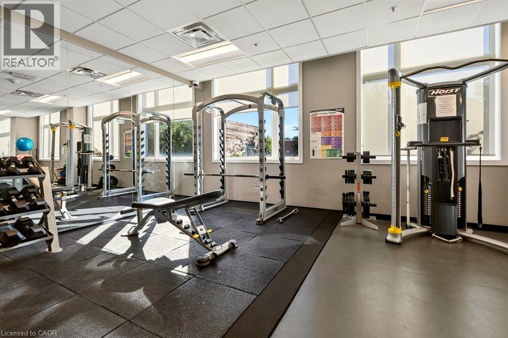 Dedicated fitness center featuring rubber flooring and mirrored walls - 457 Plains Road Unit# 225, Burlington, ON