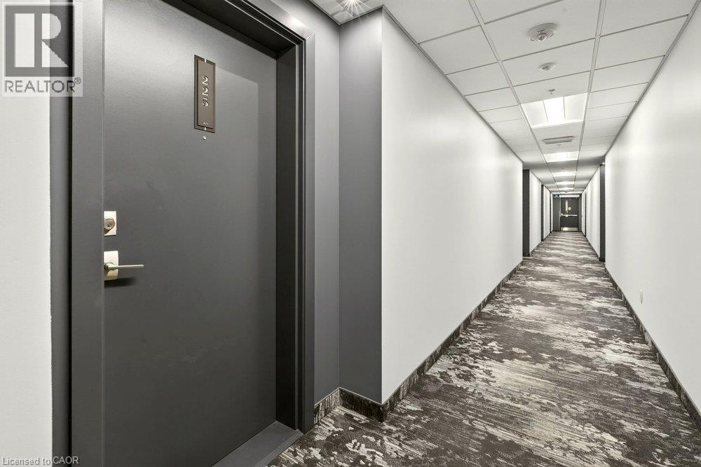 Entry door with contemporary hardware and unit numbering - 457 Plains Road Unit# 225, Burlington, ON