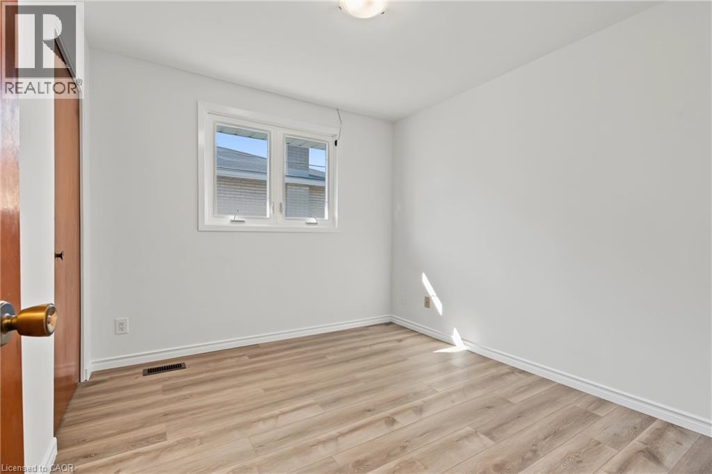 BEDROOM 2, closet, large vinyl window & NEW vinyl flooring. - 589 Mohawk Road W, Hamilton, ON