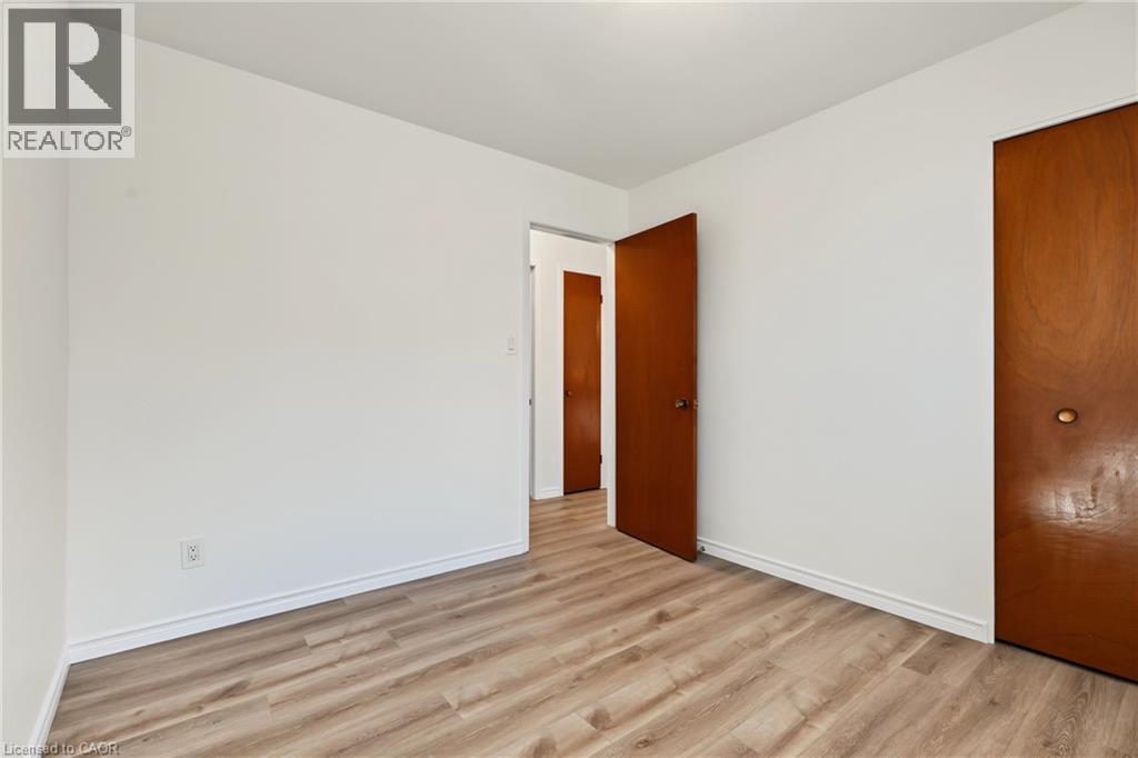 BEDROOM 2, closet, large vinyl window & NEW vinyl flooring. - 589 Mohawk Road W, Hamilton, ON