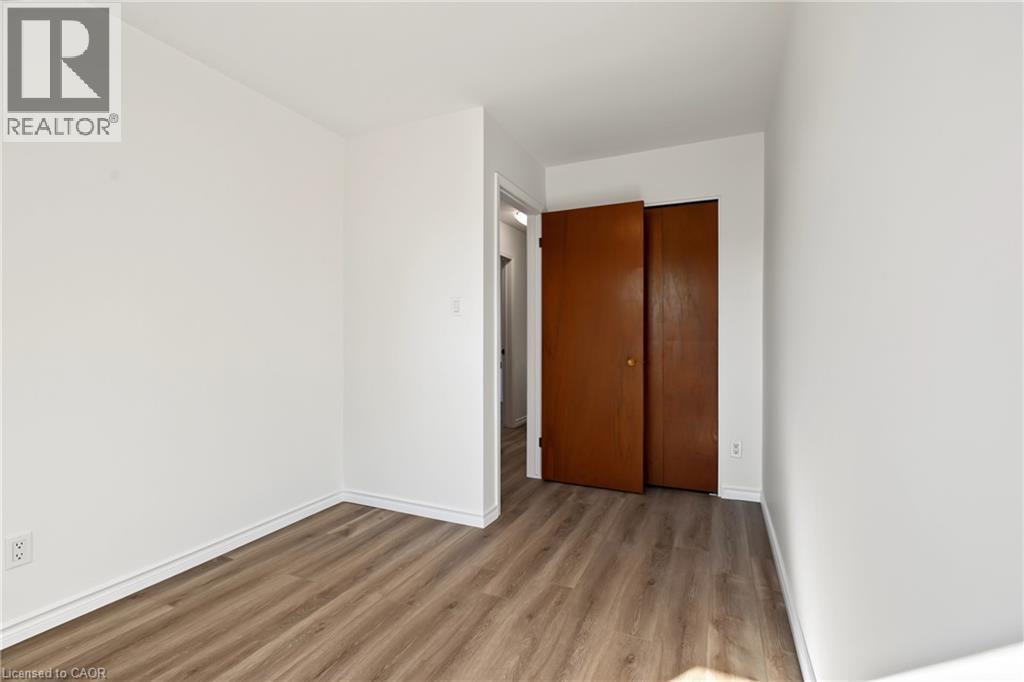BEDROOM 3, closet, large vinyl window & NEW vinyl flooring. - 589 Mohawk Road W, Hamilton, ON