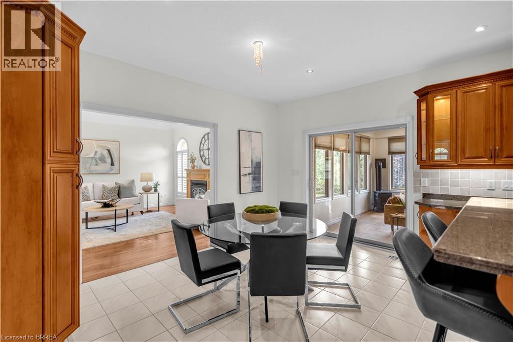 Kitchen-dining area featuring light-toned tile flooring, recessed lighting, and a chandelier fixture - 302 German School Road, Paris, ON