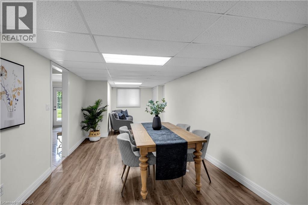 Spacious room featuring wood-finish flooring, crisp white walls, and a dropped ceiling with integrated lighting - 302 German School Road, Paris, ON