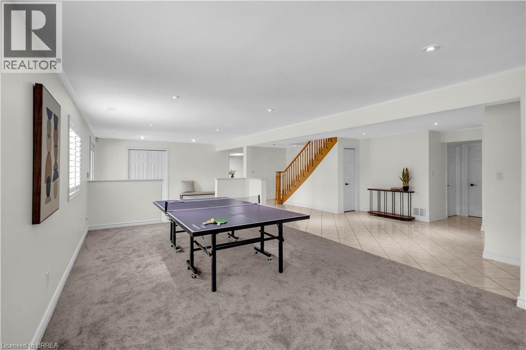 Spacious lower level featuring dual flooring types with plush carpeting and large format tile, recessed lighting, and a bright white color palette - 302 German School Road, Paris, ON