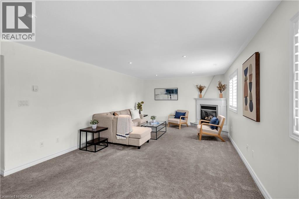 Living space featuring a corner fireplace with white mantel, recessed lighting, and carpet flooring - 302 German School Road, Paris, ON