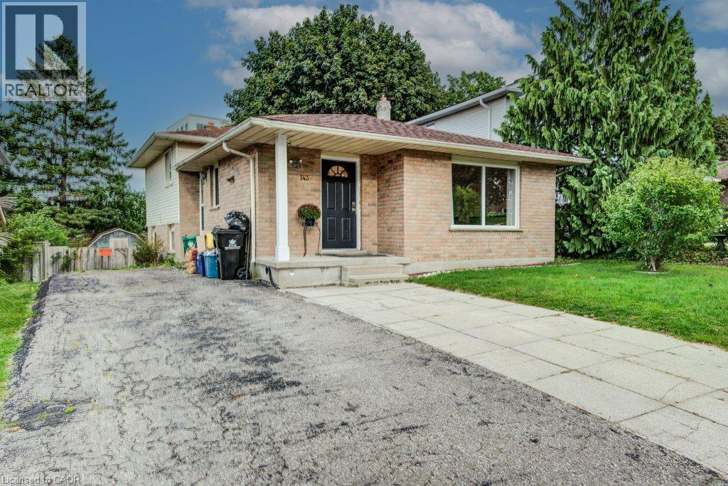 Brick exterior with a prominent entry door and side window - 143 Sunrise Place, Kitchener, ON