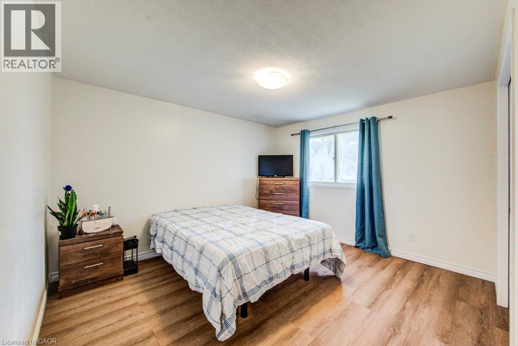 White walls and wood-finish flooring - 143 Sunrise Place, Kitchener, ON