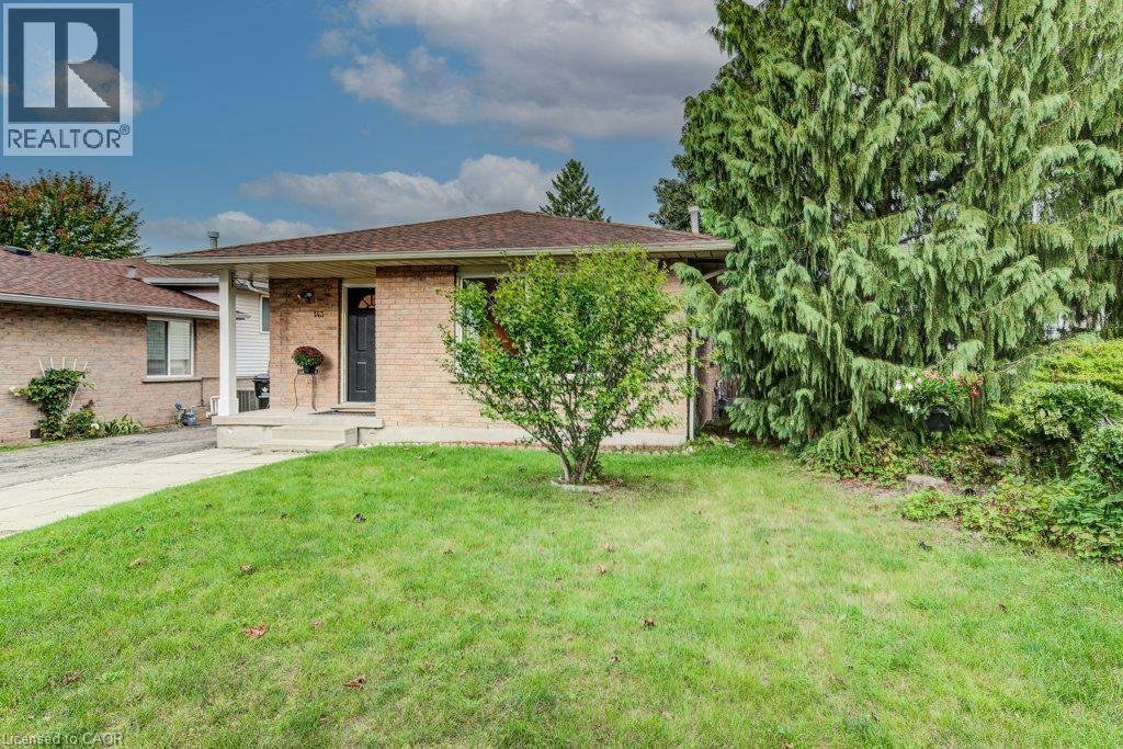 Brick exterior with a dark-framed entry door, a covered porch, and a pitched roof - 143 Sunrise Place, Kitchener, ON