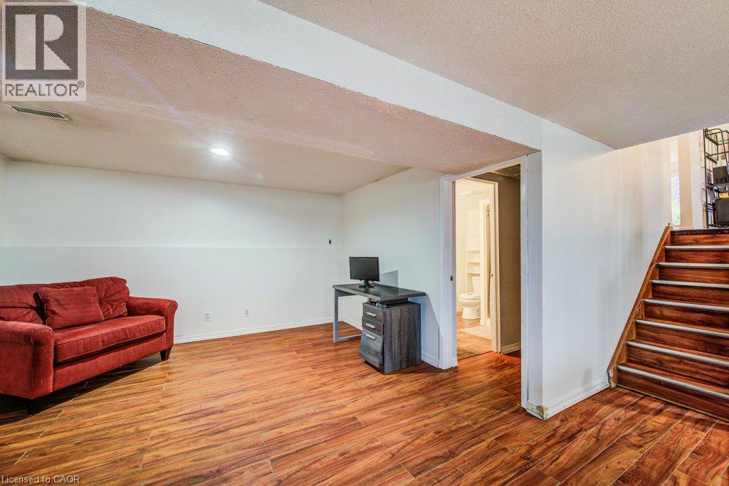 Wood-finish flooring throughout the space - 143 Sunrise Place, Kitchener, ON
