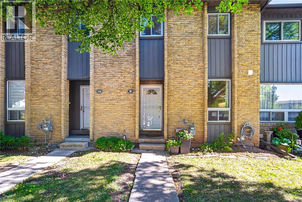 Multi-story facade featuring stacked stone and vertical siding - 1517 Elm Road Unit# 9, Oakville, ON