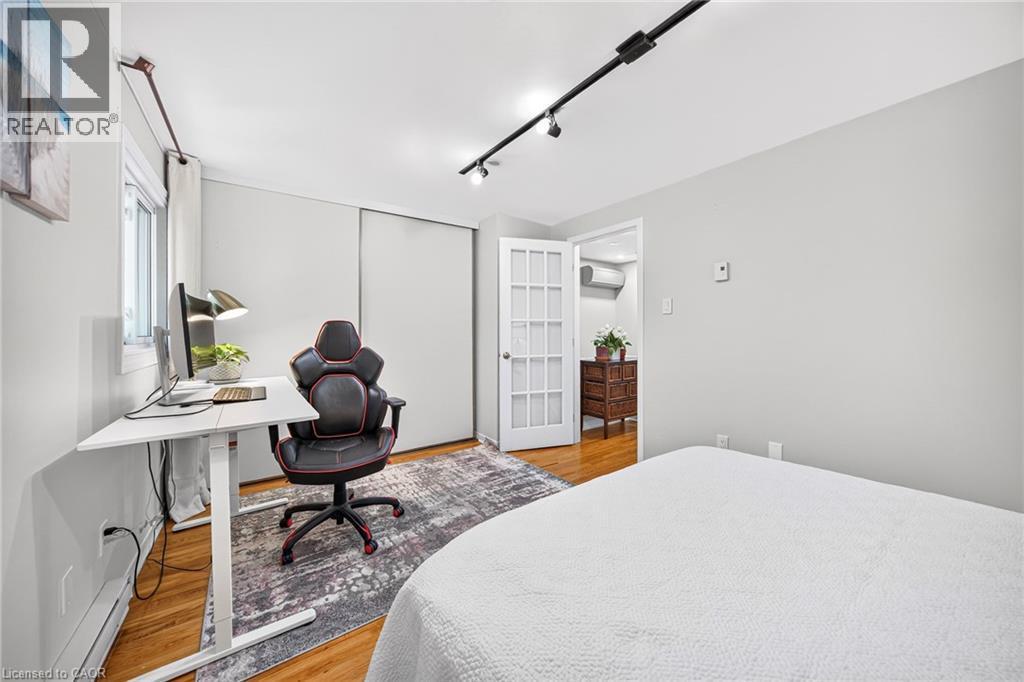Hardwood flooring, track lighting, white trim, white walls, and a white French door - 1517 Elm Road Unit# 9, Oakville, ON