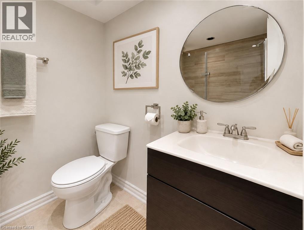 Dark wood-finish vanity with an integrated white sink and chrome faucet - 1517 Elm Road Unit# 9, Oakville, ON