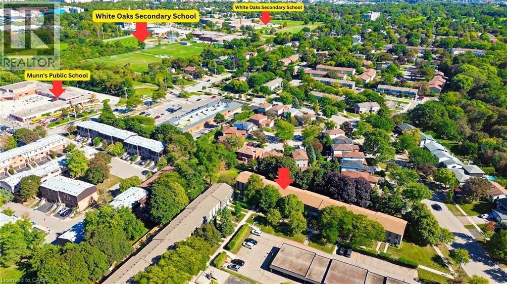Aerial perspective of a residential area with multiple detached and attached properties, established tree cover, and paved roadways - 1517 Elm Road Unit# 9, Oakville, ON