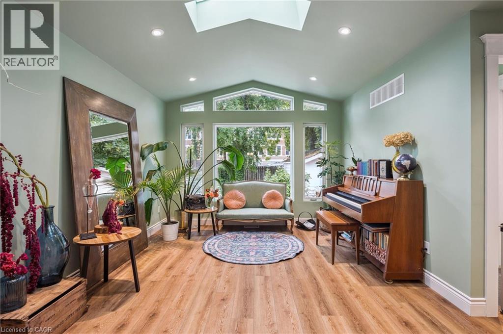 Vaulted ceiling with skylight, recessed lighting, carpet-free floor, and expansive windows - 58 Balmoral Avenue N, Hamilton, ON