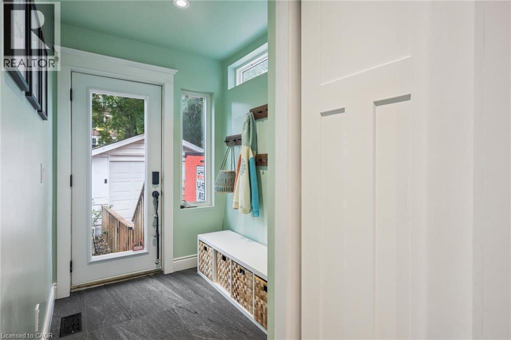 Bright mudroom entry featuring recessed lighting, closet, and dark slate tile flooring - 58 Balmoral Avenue N, Hamilton, ON