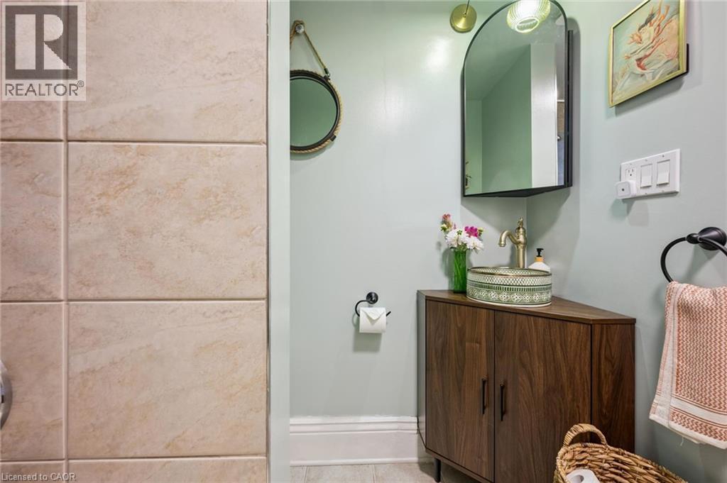 Vanity with decorative vessel sink and brass-finish faucet - 58 Balmoral Avenue N, Hamilton, ON