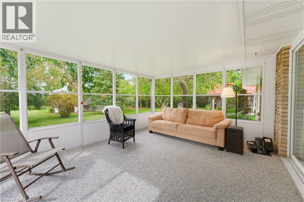Enclosed patio featuring abundant natural light, a textured floor finish, and white paneled walls - 15 Mclaren Avenue N, Listowel, ON