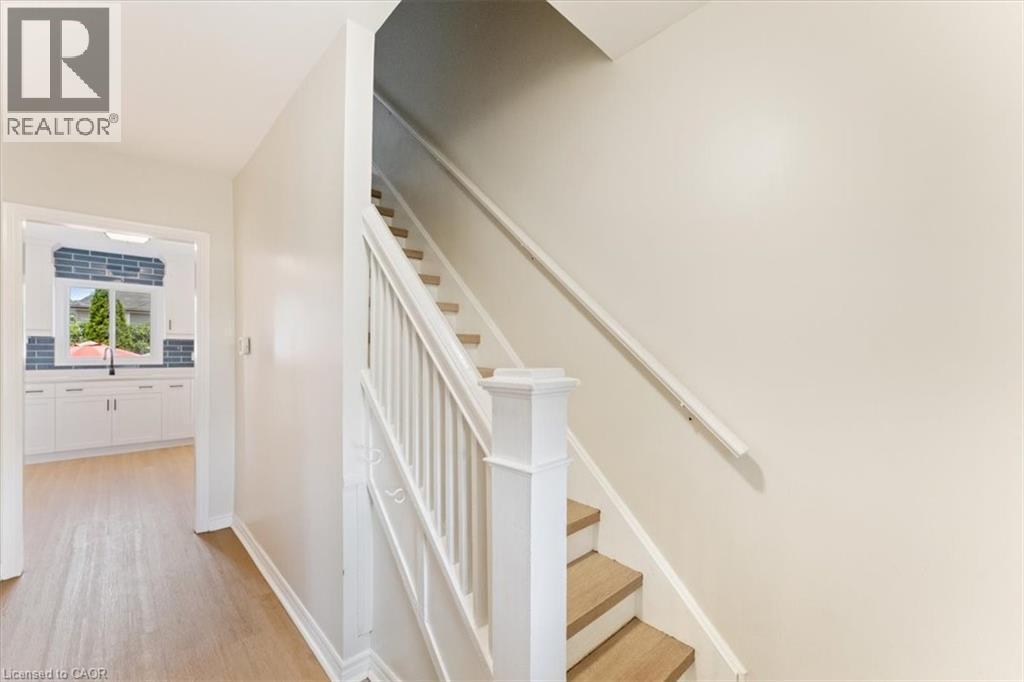 Staircase with wood-finish treads and white risers - 17 Craigmiller Avenue, Hamilton, ON