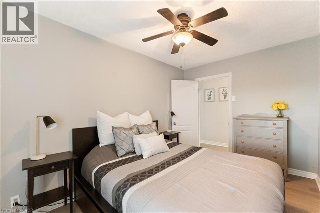 Room featuring light gray walls and wood-finish flooring - 17 Craigmiller Avenue, Hamilton, ON