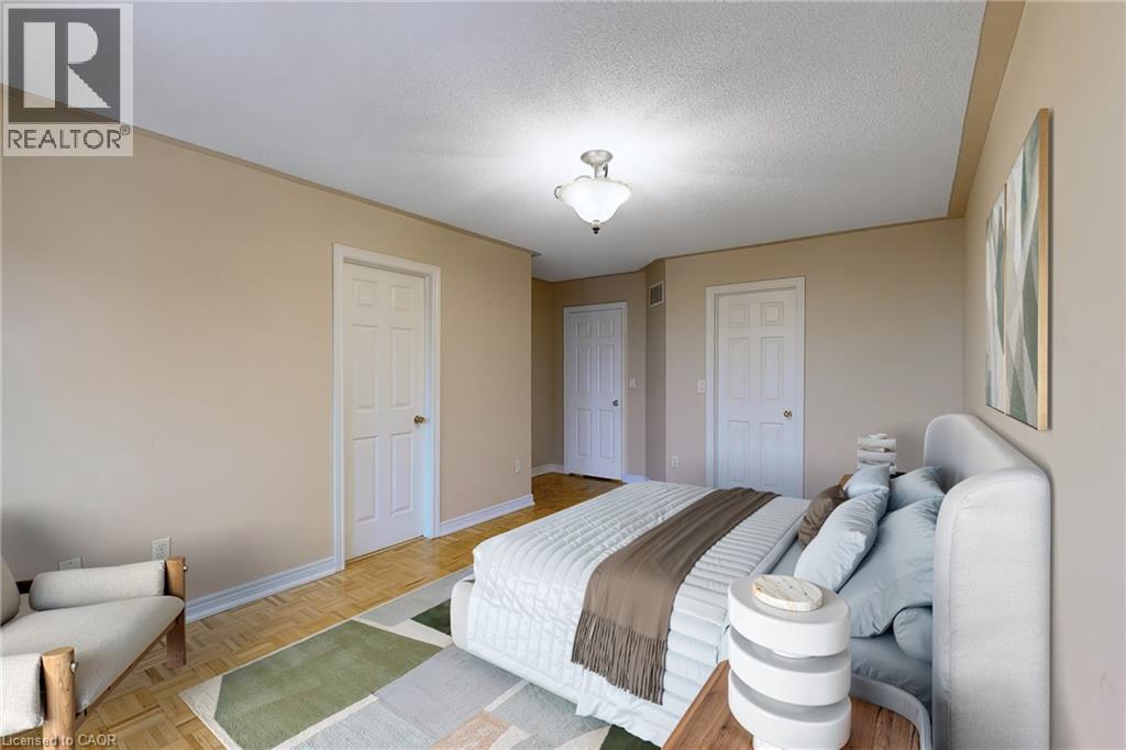 Beige wall paint, white trim, wood-finish parquet flooring, two paneled doors, and a ceiling-mounted light fixture - 21 Eastview Gate Unit# 36, Brampton, ON