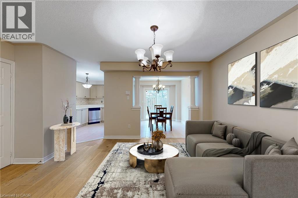 Wood-finish flooring throughout, with a classic chandelier and recessed lighting - 21 Eastview Gate Unit# 36, Brampton, ON