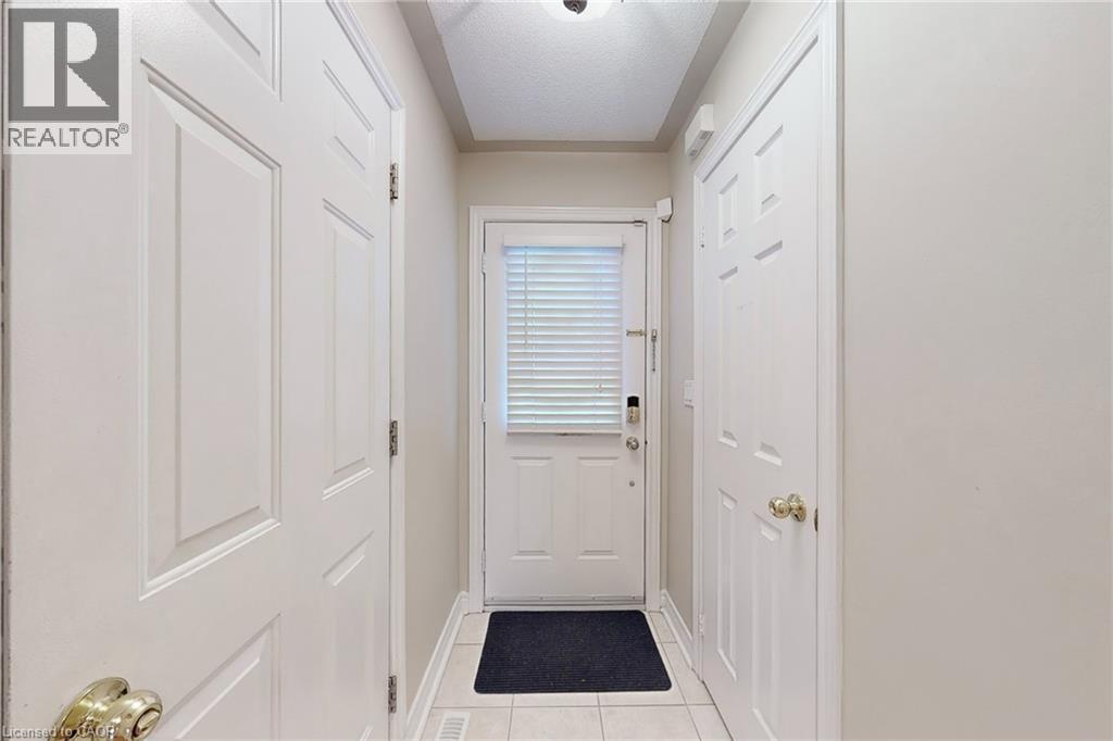 Tiled flooring, white paneled doors, and ceiling-mounted lighting fixture - 21 Eastview Gate Unit# 36, Brampton, ON