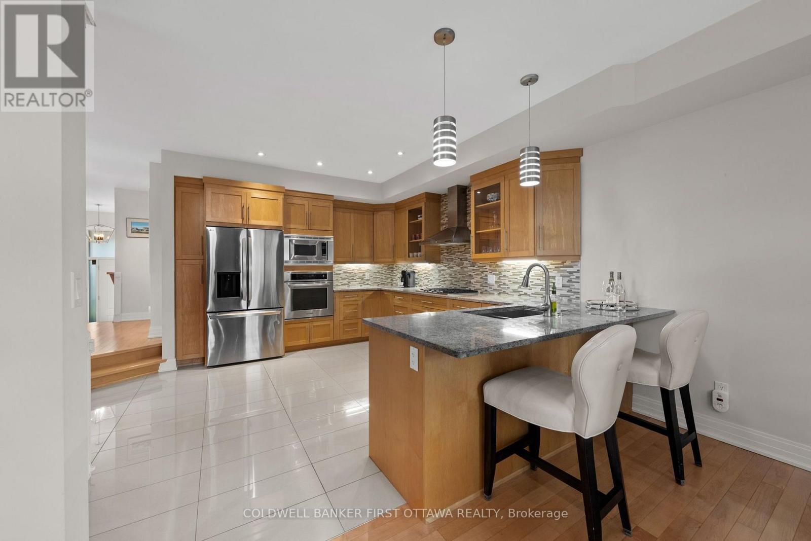 Breakfast bar seating w pendant lighting above. - 155 Nora Street, Ottawa, ON