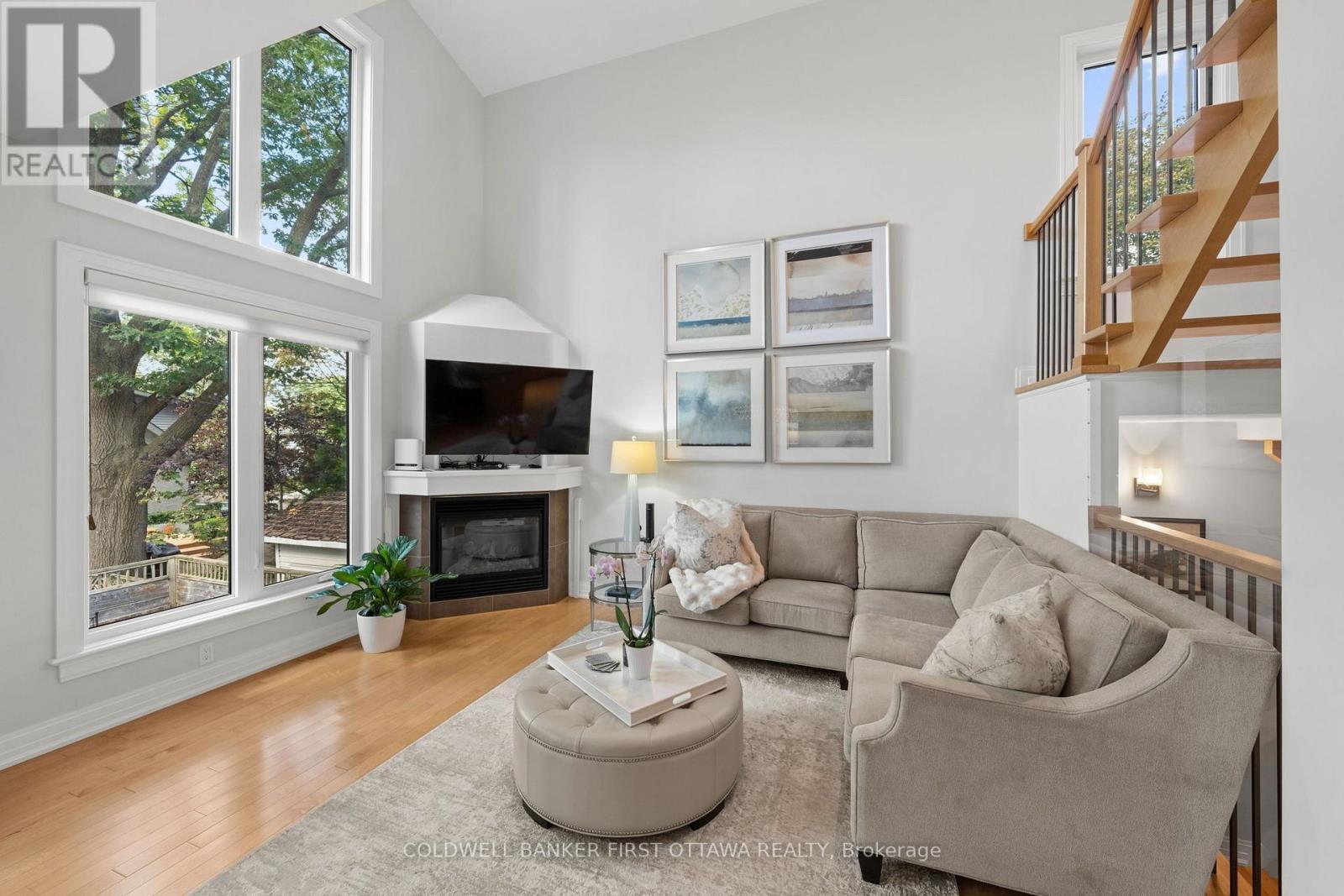 Floor to ceiling windows & built in gas fireplace. - 155 Nora Street, Ottawa, ON