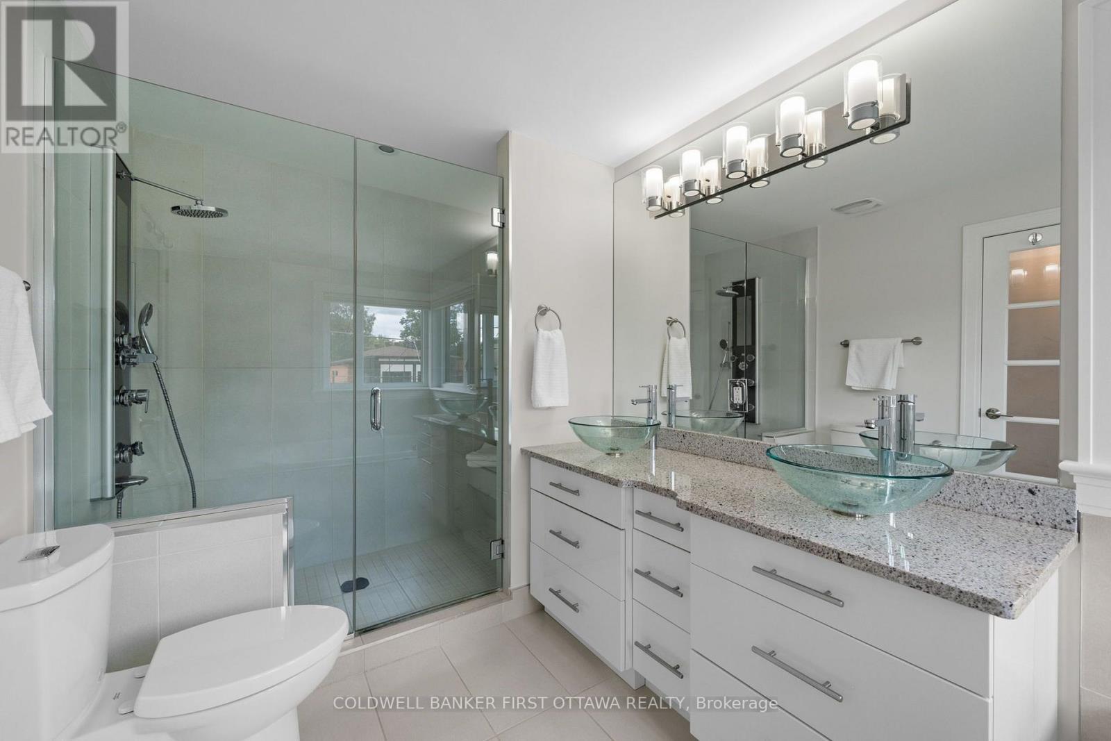 Glass enclosed shower w/ bench & granite counters. - 155 Nora Street, Ottawa, ON