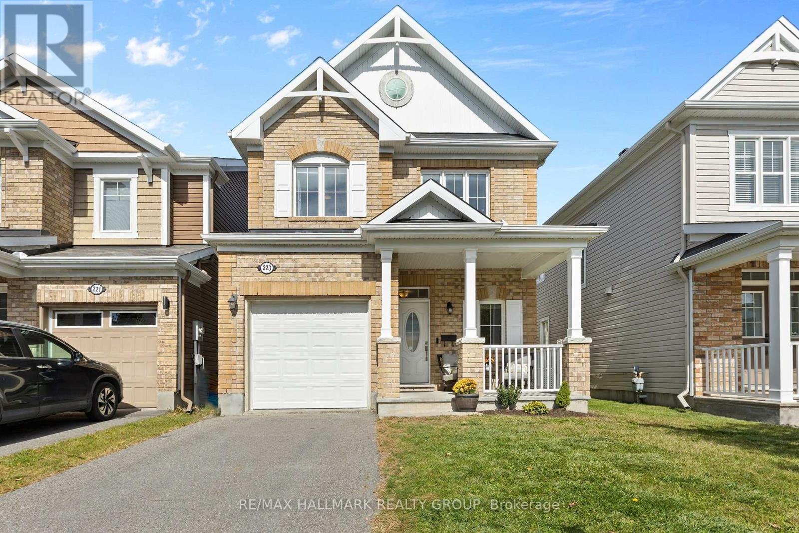 Front exterior with brick façade and garage - 223 Serra Ridge, Ottawa, ON