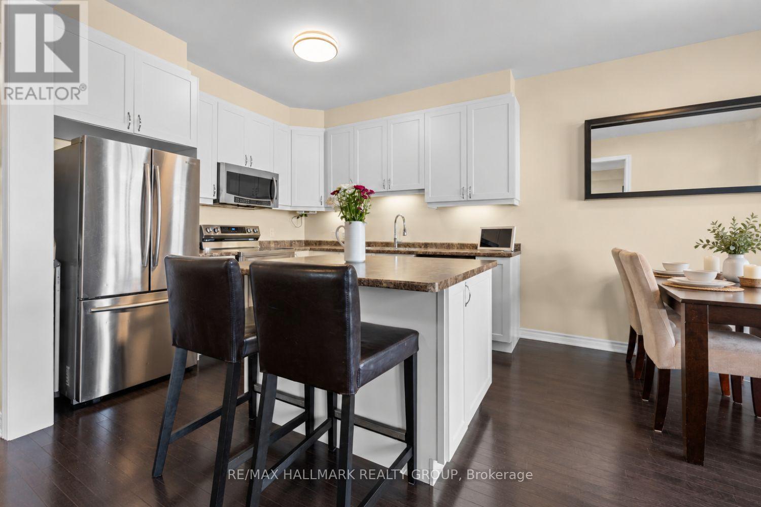 Modern kitchen with island and dining area - 223 Serra Ridge, Ottawa, ON